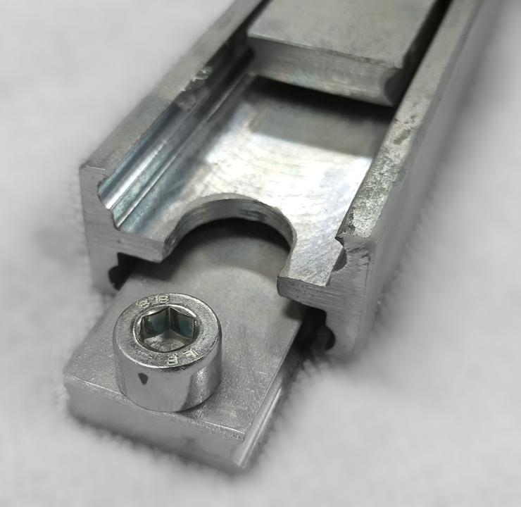 Close-up of a heavy-duty telescopic drawer slide made of steel, showing the slide's full extension mechanism.