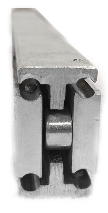 Close-up of a heavy-duty telescopic drawer slide made of steel, showing the slide's full extension mechanism.