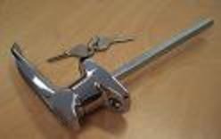 A chrome-plated T-handle with a keyed rear fixing, displayed on a light background, accompanied by a small package of fasteners.